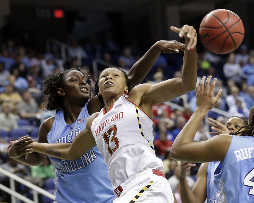 Maryland's Alicia DeVaughn, right, has her shot blocked by North Carolina's Waltiea Rolle, left, during the second half of an NCAA college basketball game at the Atlantic Coast Conference tournament in Greensboro, N.C., Saturday, March 9, 2013. North Carolina won 72-65. (AP Photo/Chuck Burton)
