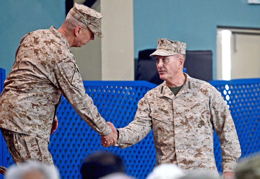 Gen. Joseph F. Dunford, Jr., (right) takes the hand and the command of Gen. John Allen during a February ceremony in Kabul, Afghanistan. Gen. Dunford became the fifth commander of the war in the past five years. (Associated Press)