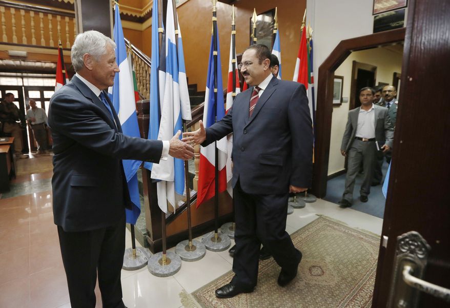 U.S. Secretary of Defense Chuck Hagel (left) meets with Afghan Interior Minister Ghulam Mujtaba Patang at the International Security Assistance Force headquarters in Kabul, Afghanistan, on Sunday, March 10, 2013. Mr. Hagel is on his first official trip since being sworn in as defense secretary. (AP Photo/Jason Reed, Pool)