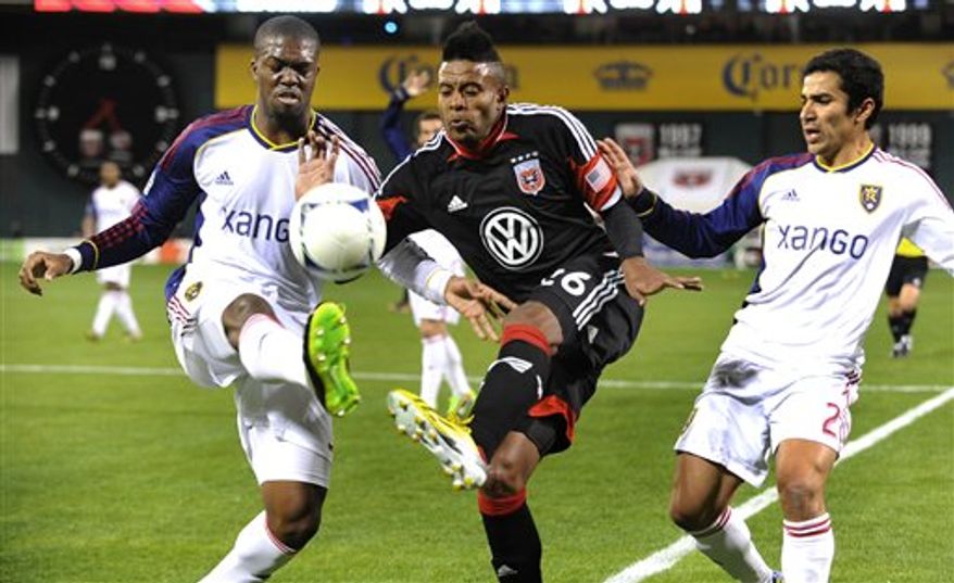 DC United forward Lionard Pajoy, center, splits the defense of Real Salt Lake's Kwame Watson-Siriboe, left, and Tony Beltran (2) during the first half of an MLS soccer game on Saturday, March 9, 2013, in Washington. DC United defeated Real Salt Lake 1-0. (AP Photo/Richard Lipski)