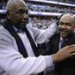 John Thompson Jr., left, congratulates his son Georgetown head coach John Thompson III, right, after an NCAA college basketball game against Syracuse, Saturday, March 9, 2013, in Washington. Georgetown won 61-39 over Syracuse. (AP Photo/Nick Wass) **FILE**