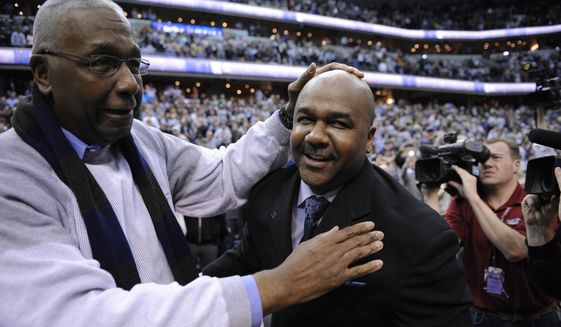 John Thompson Jr., left, congratulates his son Georgetown head coach John Thompson III, right, after an NCAA college basketball game against Syracuse, Saturday, March 9, 2013, in Washington. Georgetown won 61-39 over Syracuse. (AP Photo/Nick Wass) **FILE**