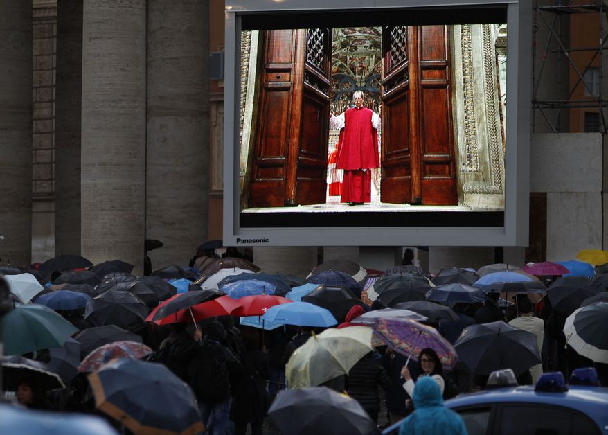 People watch on a video monitor in St. Peter's Square as Monsignor Guido Marini, master of liturgical ceremonies, closes the double doors to the Sistine Chapel in Vatican City Tuesday, March 12, 2013, at the start of the conclave of cardinals to elect the next pope. Marini closed the doors after shouting "Extra omnes," Latin for "all out," telling everyone but those taking part in the conclave to leave the frescoed hall. He then locked it. (AP Photo/Michael Sohn)