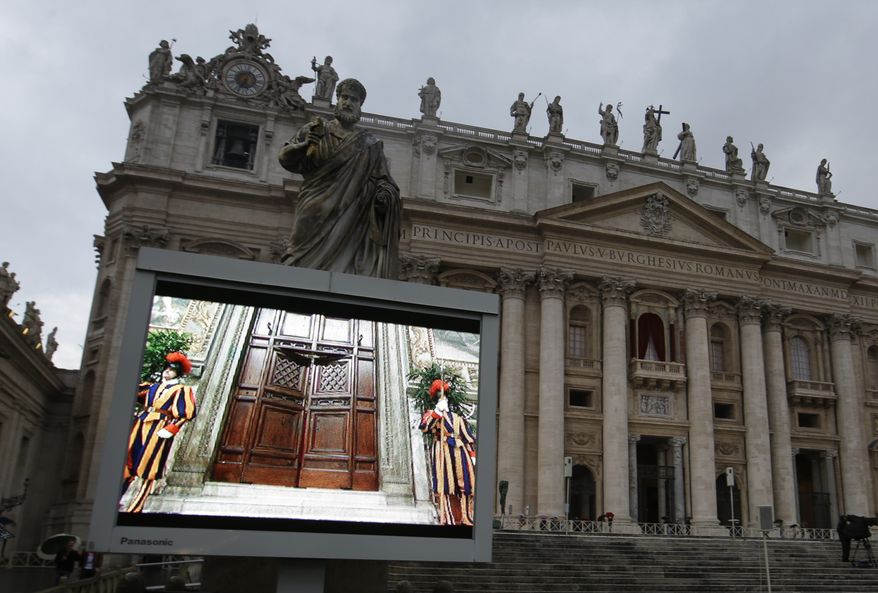 A giant monitor in St. Peter's Square at the Vatican, Tuesday, March 12, 2013, shows the heavy wooden door to the Sistine Chapel being closed and locked, signaling the start of the conclave to elect a new pope to succeed Benedict XVI following his stunning resignation. Monsignor Guido Marini, master of liturgical ceremonies, closed the double doors after shouting "Extra omnes," Latin for "all out," telling everyone but those taking part in the conclave to leave the frescoed hall. He then locked it. (AP Photo/Gregorio Borgia)