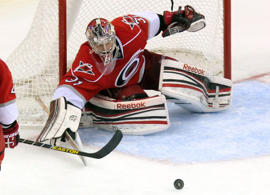 Carolina Hurricanes goalie Dan Ellis guards the goal against the New Jersey Devils during the third period of the Hurricanes' 6-3 win in Raleigh, N.C., on March 9, 2013. (Associated Press)