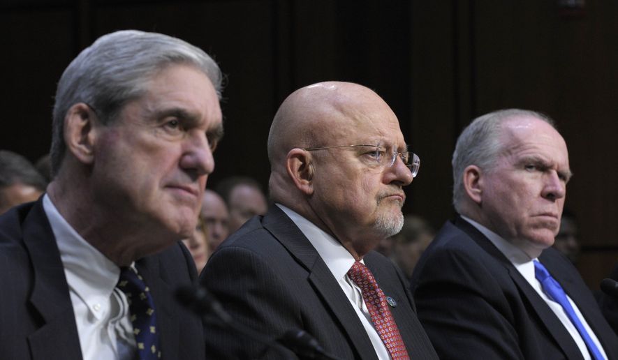 Director of National Intelligence James Clapper, center, flanked by FBI Director Robert Mueller, left, and CIA Director John Brennan, right, listen during the Senate Intelligence Committee annual open hearing on worldwide threats on Capitol Hill in Washington, Tuesday, March 12, 2013. (AP Photo/Susan Walsh)
