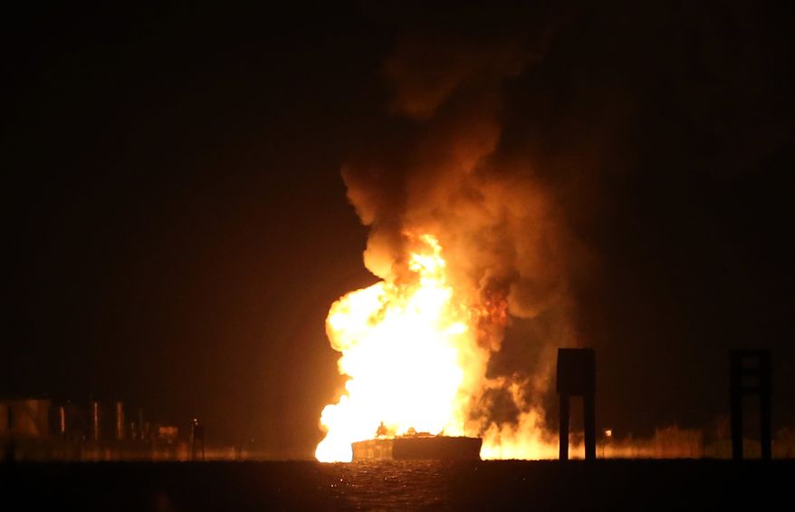 A tugboat and barge are engulfed in flames after hitting a pipeline carrying liquefied petroleum gas in Bayou Perot, about two miles south of lower Lafitte, La., on Tuesday, March 12, 2013. (AP Photo/Michael DeMocker, Nola.com/The Times-Picayune)