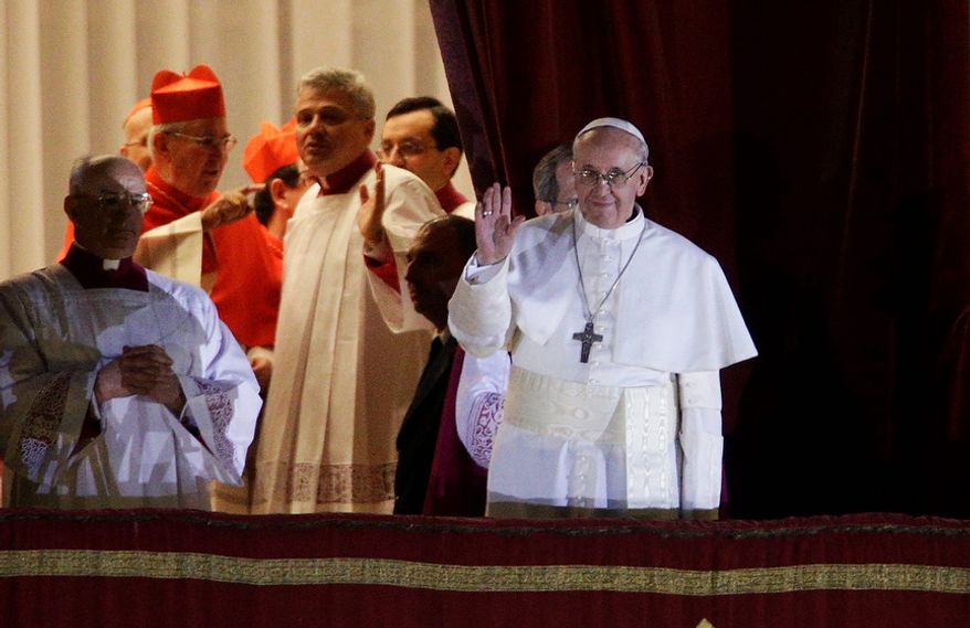 Pope Francis flanked by Monsignor Guido Marini, master of liturgical ceremonies, waves to the crowd from the central balcony of St. Peter's Basilica at the Vatican, Wednesday, March 13, 2013. Cardinal Jorge Bergoglio, who chose the name of Francis is the 266th pontiff of the Roman Catholic Church. (AP Photo/Andrew Medichini)