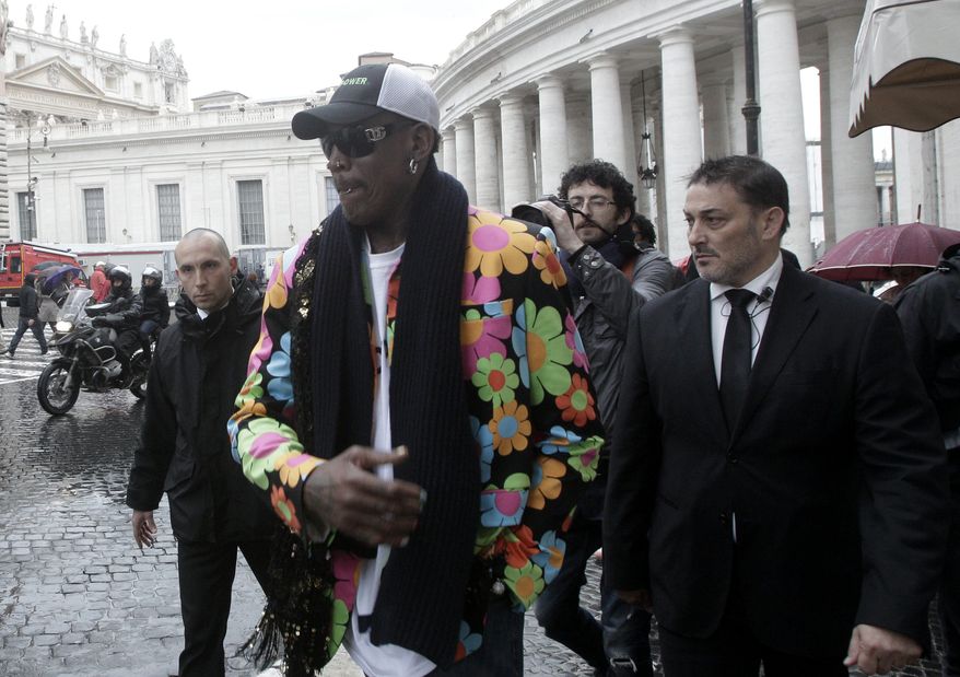 Former NBA star Dennis Rodman walks by the Bernini Colonnade near St. Peter's Square at the Vatican, Wednesday, March 13, 2013. Rodman is in Rome to promote the papal candidacy of Cardinal Peter Turkson of Ghana. ((AP Photo/Riccardo De Luca)