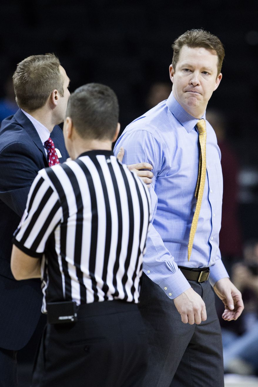 Richmond's head coach Chris Mooney reacts to a game-changing foul call during the second half of an NCAA college basketball game against Charlotte at the Atlantic 10 Conference tournament in New York, Thursday, March 14, 2013. Pierria Henry hit eight free throws in the final five seconds of a wild start to the tournament, and Charlotte stunned Richmond 68-63. (AP Photo/John Minchillo)