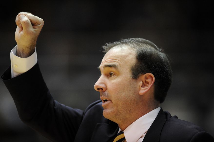**FILE** George Washington head coach Mike Lonergan gestures during the second half of an NCAA college basketball game against Butler, Saturday, Feb. 9, 2013, in Washington. Butler won 59-56. (AP Photo/Nick Wass)