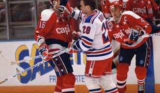 **FILE** New York Rangers Tie Domi (28) shoves his glove in the face of Washington Capitals Alan May after the two exchanged words during the first period of their game at New York&#39;s Madison Square Garden, Nov. 11, 1992. (AP Photo/Ron Frehm)