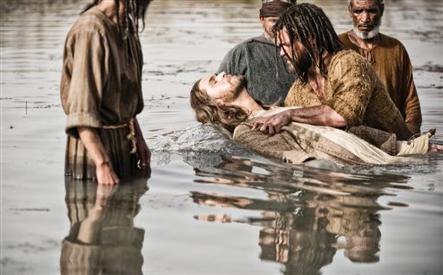 Diogo Morgado as Jesus, center, is baptized by Daniel Percival, as John, in a scene from History's "The Bible." The five-part mini-series, produced by the husband-and-wife team of Mark Burnett and Roma Downey, concluded March, 31. The producers now plan on bringing the story to the big screen. (AP Photo/History, Joe Alblas)