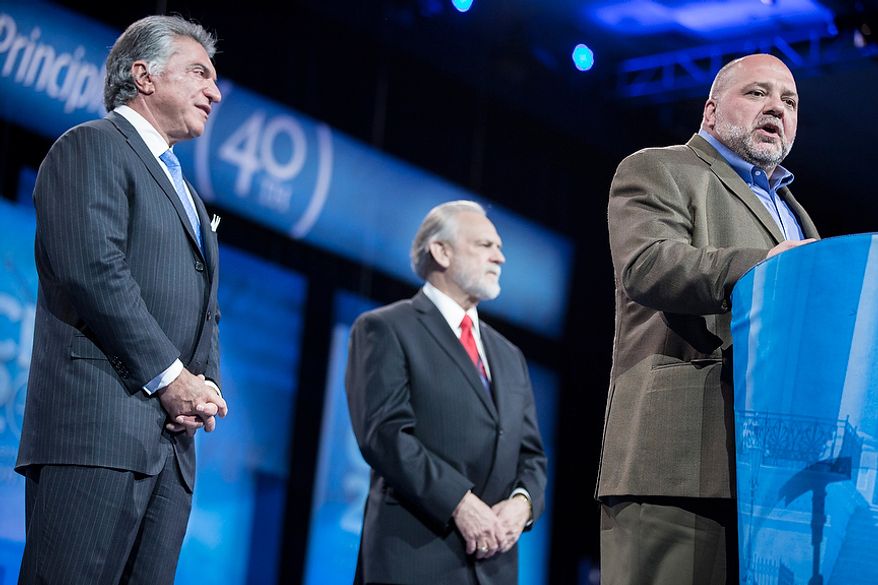 Tony Fabrizio, from right, of the Fabrizio-McLaughlin polling firm, announces the results of the Washington Times/CPAC 2013 straw poll with Larry Beasley, president and CEO of The Washington Times, and Al Cardenas, chairman of the American Conservative Union, during the final day of the 2013 Conservative Political Action Conference in Fort Washington, Md. on March 16, 2013. Sen. Rand Paul (R-KY) was the winner, narrowly edging out the close second place Sen. Marco Rubio (R-FL). (T.J. Kirkpatrick/Special to The Washington Times)