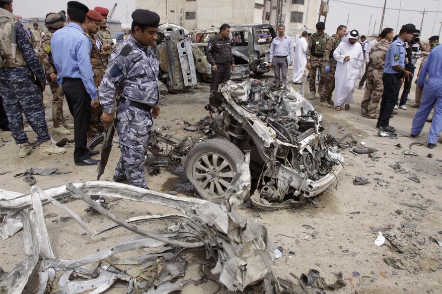 Iraqi security forces inspect the site of a car bomb attack in Basra, Iraq, on Sunday, March 17, 2013. The blast was one of two to hit the oil-rich southern city within minutes of each other. (AP Photo/Nabil al-Jurani)