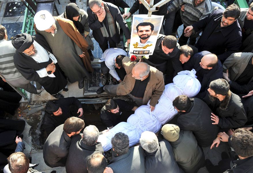 TARGETED: Mostafa Ahmadi Roshan, a chemistry specialist and a director of a uranium enrichment facility Iran, was killed in 2012 when a magnetic bomb was attached to his car and then exploded. A crowd surrounds his body. (Associated Press)