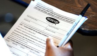 **FILE** A Yazoo City, Miss., resident holds copies of a Medicare-approved drug card application on July 27, 2004, in Yazoo City. (Associated Press)
