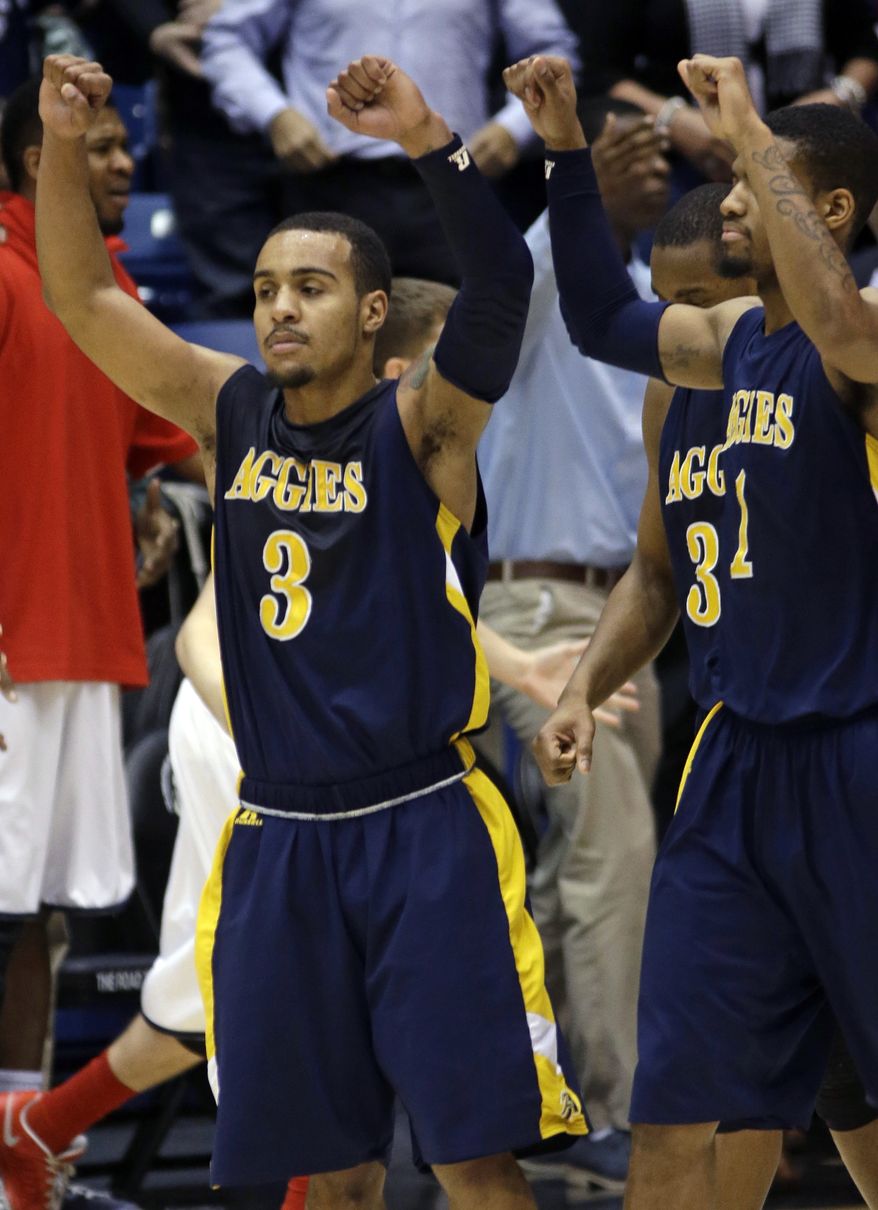 North Carolina A&T guard Jeremy Underwood (3) celebrates after they defeated Liberty 73-72 in a first round NCAA college basketball tournament game, Tuesday, March 19, 2013, in Dayton, Ohio. Underwood led North Carolina A&T with 19 points. (AP Photo/Al Behrman)