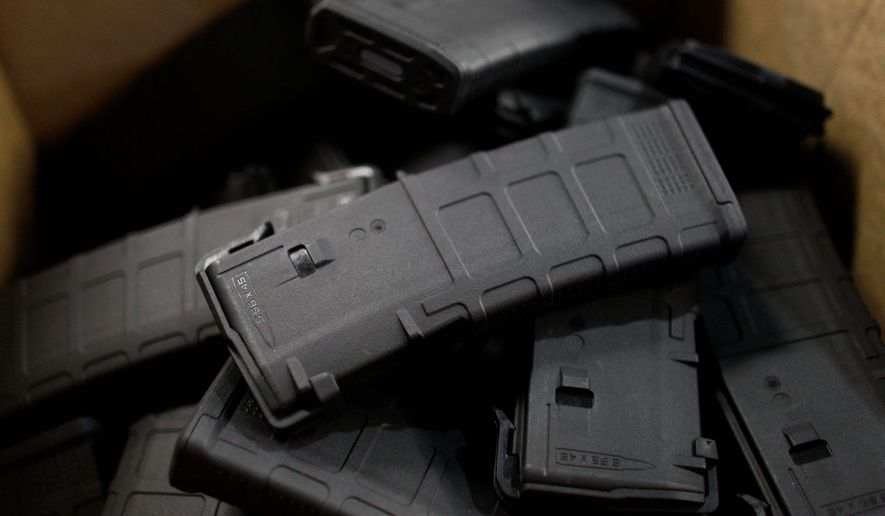 Newly-assembled 30-round capacity ammunition magazines for high-velocity rifles are stacked awaiting packaging inside the Magpul Industries plant, in Erie, Colo. The company plans to relocate now that gun control bills have become law. (Associated Press)