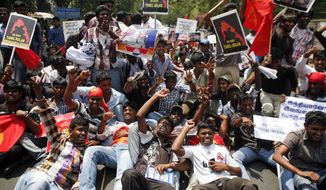 Indian Tamil activists and supporters lie on a road and shout slogans during a protest against Sri Lanka&#39;s alleged wartime abuses in Chennai, India, on March 21, 2013. A key ethnic Tamil party withdrew from India&#39;s coalition government Tuesday, accusing the government of watering down a U.N. resolution criticizing Sri Lanka&#39;s war-time conduct against its minority Tamil population. The party has demanded the U.N. Human Rights Council resolution accuse Sri Lanka of genocide and that it leads to the formation of an international inquiry into possible war crimes. (Associated Press)