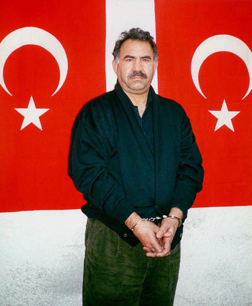 ** FILE ** In this file photo provided by the Turkish Intelligence Service on Feb. 18, 1999, Kurdish rebel leader Abdullah Ocalan poses in front of Turkish flags before being interrogated by Turkish officials at the prison-island of Imrali , Turkey. (AP Photo/Turkish Intelligence Service, File)