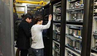 Korean Broadcasting System employees in Seoul try to recover a computer server on Thursday, March 21, 2013, a day after a cyberattack caused computer networks at the company and six South Korean banks to crash. (AP Photo/Korean Broadcasting System)


