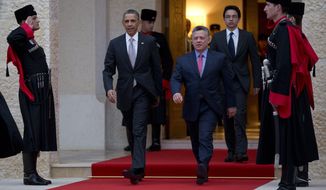 President Barack Obama walks with Jordan&#39;s King Abdullah II to participate in an official arrival ceremony at the Al-Hummar Palace, the residence of Jordanian King Abdullah II, Friday, March 22, 2013, in Amman, Jordan. (AP Photo/Carolyn Kaster)