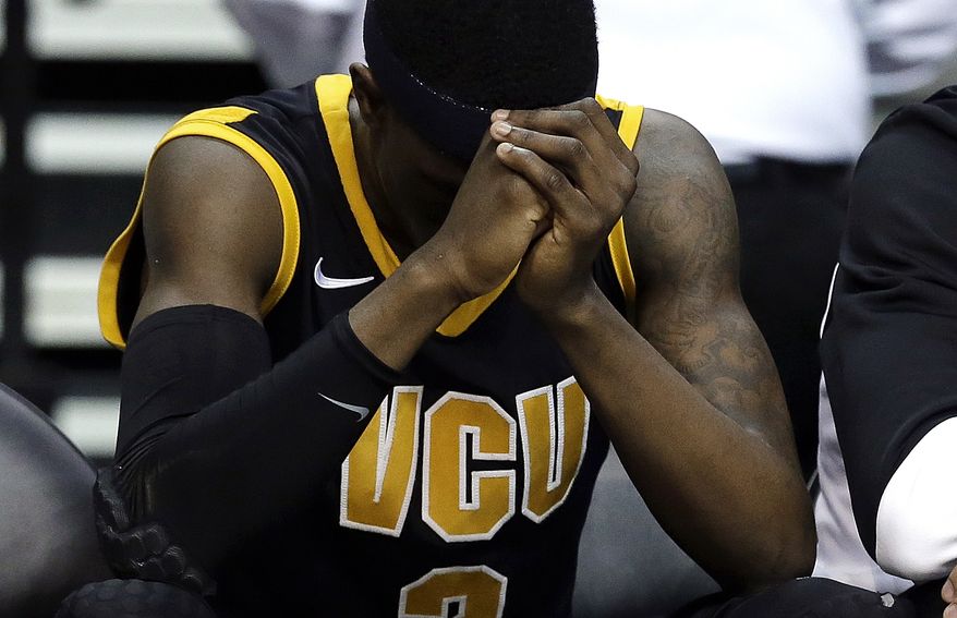 Virginia Commonwealth guard Briante Weber sits on the bench against Michigan in the second half of their third-round game of the NCAA college basketball tournament in Auburn Hills, Mich., Saturday March 23, 2013. Michigan won 78-53. (AP Photo/Paul Sancya)