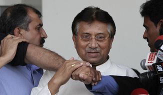 ** FILE ** Former Pakistani President Pervez Musharraf (center), surrounded by guards, arrives at the airport in Karachi, Pakistan, on Sunday, March 24, 2013, after more than four years in self-exile. Mr. Musharraf is seeking a possible political comeback in defiance of judicial probes and death threats from Taliban militants. (AP Photo/Shakil Adil)