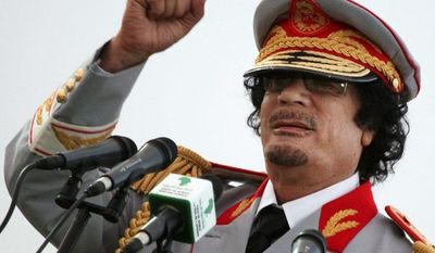 ** FILE ** Libyan dictator Moammar Gadhafi gestures during a 2010 ceremony to mark the 40th anniversary of the evacuation of American military base personnel from Libya.