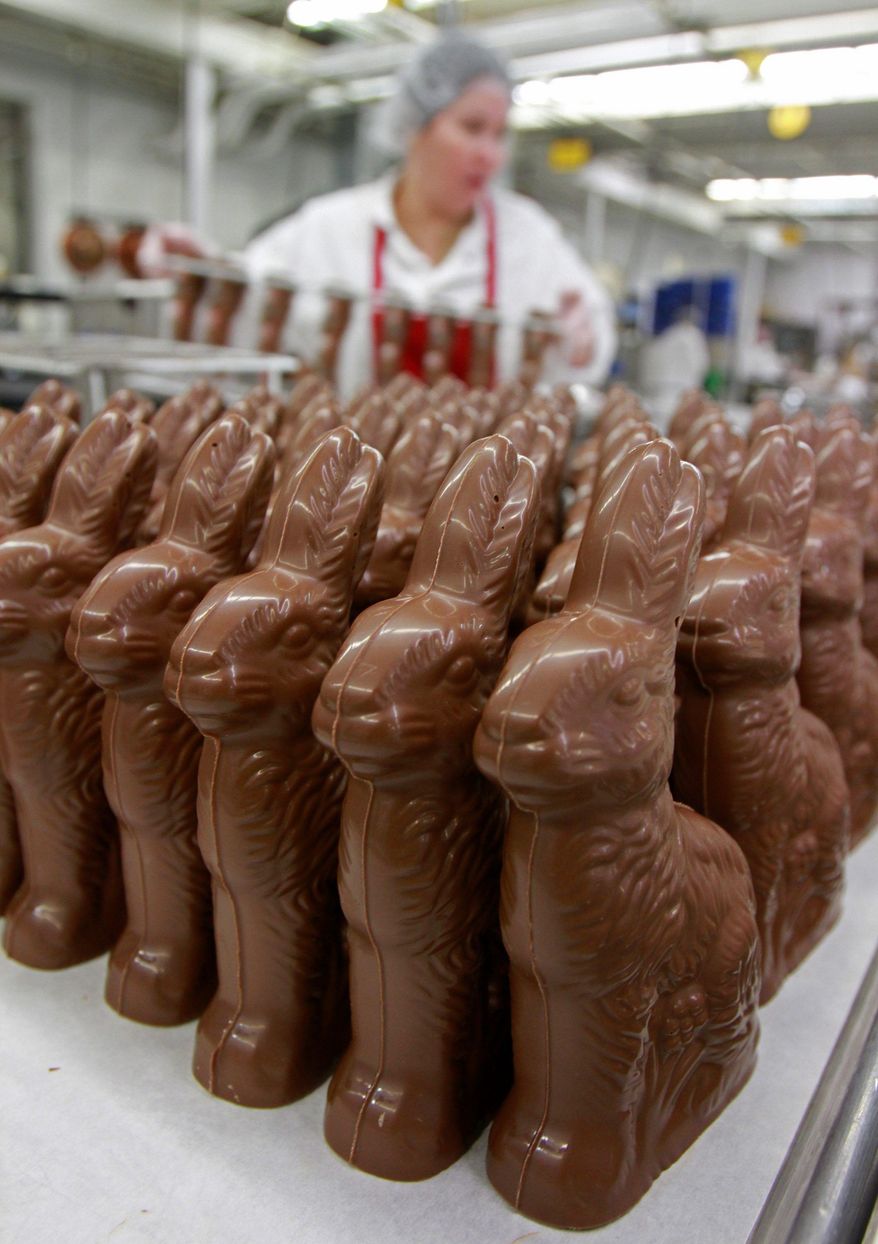 Freshly made chocolate bunnies are waiting to be placed in an Easter basket. (AP photo/file)