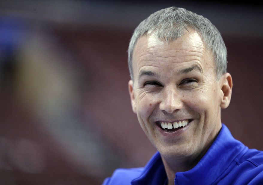 Florida Gulf Coast coach Andy Enfield laughs while talking with broadcasters during practice for a second-round game of the NCAA men's college basketball tournament, Thursday, March 21, 2013, in Philadelphia. Florida Gulf Coast is scheduled to play Georgetown on Friday. (AP Photo/Matt Slocum)
