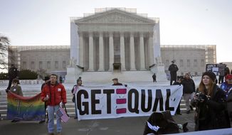 Demonstrators stand outside the Supreme Court in Washington, Tuesday, March 26, 2013, where the court will hear arguments on California’s voter approved ban on same-sex marriage, Proposition 8. (AP Photo/Pablo Martinez Monsivais)