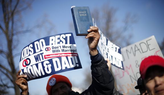 A demonstrator holds a bible while marching outside the Supreme Court in Washington, Tuesday, March 26, 2013, as the court heard arguments on California&#39;s voter approved ban on same-sex marriage, Proposition 8. (AP Photo/Pablo Martinez Monsivais)

