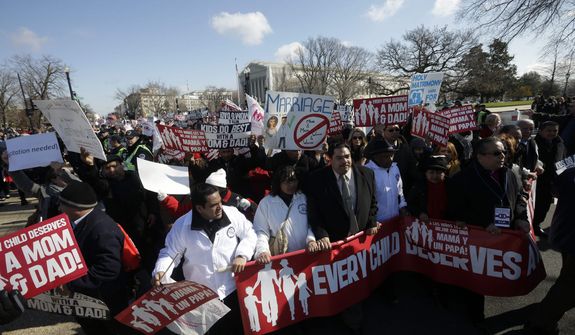 Demonstrators march outside the Supreme Court in Washington, Tuesday, March 26, 2013, where the justices were hearing arguments on California&#39;s voter approved ban on same-sex marriage, Proposition 8. (AP Photo/Pablo Martinez Monsivais)


