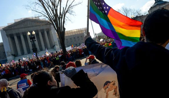Franco Ciammachilli (right) of Washington waves a rainbow flag, a symbol of gay pride, behind supporters of traditional marriage outside the U.S. Supreme Court in Washington as the justices began hearing two days of arguments in cases involving gay marriage on March 26, 2013. (Andrew Harnik/The Washington Times) **FILE** 