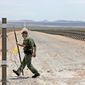 ** FILE ** A road lined with vehicle barriers marking the U.S-Mexico border in New Mexico is the spartan territory for Border Patrol agents. (Associated Press)