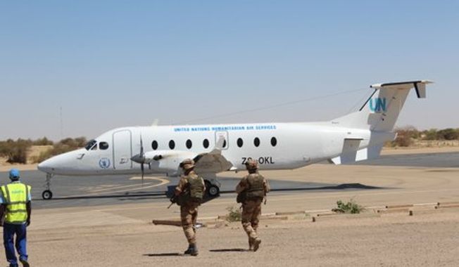 March 22: A U.N. Humanitarian Air Service plane comes to pick up journalists. (Photo by John Price)