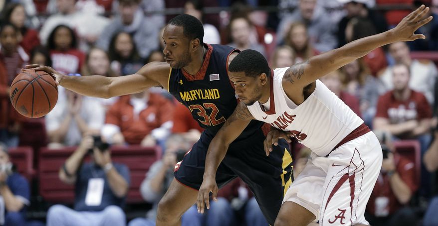 Maryland's Dez Wells (32) keeps the ball from Alabama guard Trevor Releford during the first half of an NIT college basketball game in Tuscaloosa, Ala., Tuesday, March 26, 2013. (AP Photo/Dave Martin)