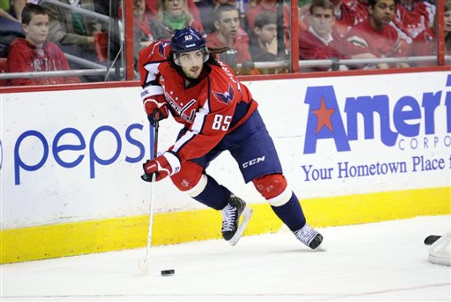 Washington Capitals center Mathieu Perreault (85) skates with the puck against the Buffalo Sabres during the second period of an NHL hockey game, Sunday, March 17, 2013, in Washington. (AP Photo/Nick Wass)
