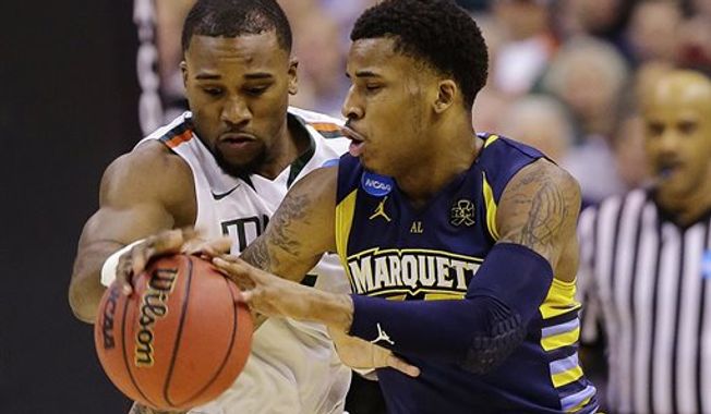 Marquette guard Vander Blue, right, drives around Miami forward Erik Swoope during the first half of an East Regional semifinal in the NCAA college basketball tournament, Thursday, March 28, 2013, in Washington. (AP Photo/Alex Brandon)