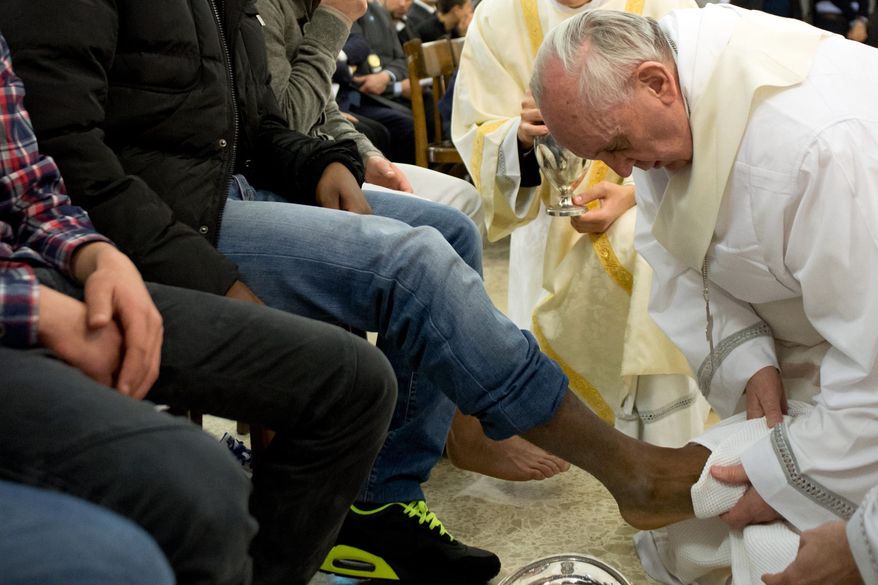 In this photo provided by the Vatican newspaper L'Osservatore Romano, Pope Francis washes the foot of an inmate at the juvenile detention center of Casal del Marmo, Rome, Thursday, March 28, 2013. Francis washed the feet of a dozen inmates at a juvenile detention center in a Holy Thursday ritual that he celebrated for years as archbishop and is continuing now that he is pope. Two of the 12 were young women, an unusual choice given that the rite re-enacts Jesus' washing of the feet of his male disciples. (AP Photo/L'Osservatore Romano, ho)