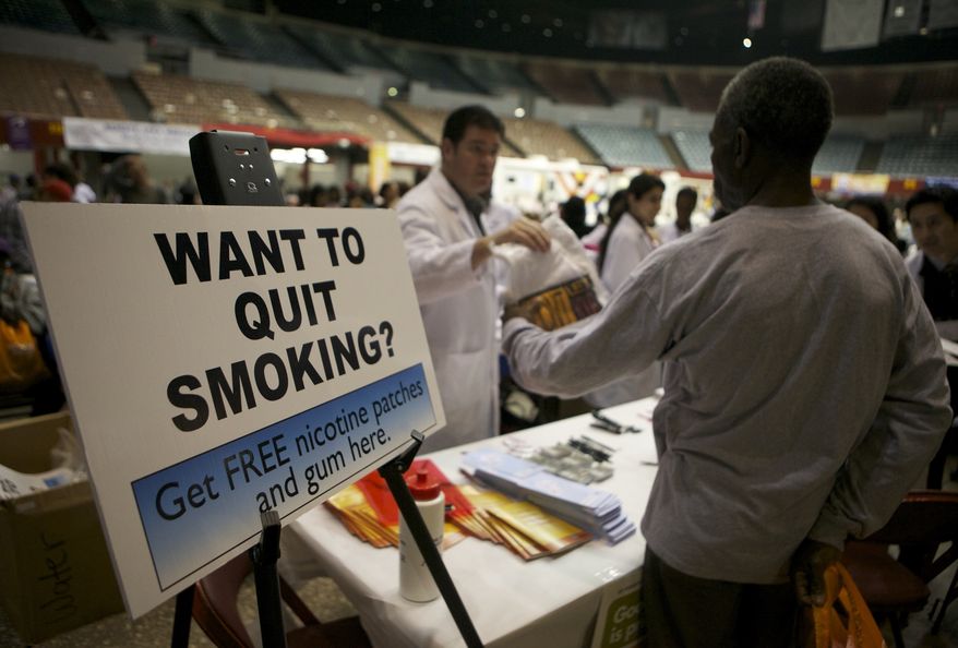 **FILE** Smokers without medical insurance receive free nicotine patches and gum at the Remote Area Medical (RAM) clinic inside the Los Angeles Sports Arena in Los Angeles on April 27, 2010. (Associated Press)
