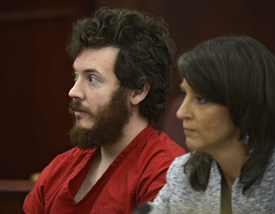 **FILE** Aurora, Colo., theater shooting suspect James Holmes and defense attorney Tamara Brady sit in the courtroom during his arraignment in Centennial, Colo., on Tuesday, March 12, 2013. (Associated Press/Denver Post)