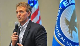 Sen. Jeff Flake, Arizona Republican, answers questions from the crowd about immigration reform, gay marriage and other topics on March 28, 2013, during a town-hall-style meeting at Embry-Riddle Aeronautical University in Prescott, Ariz. (Associated Press/The Daily Courier) ** FILE **