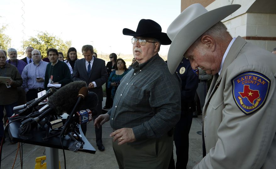 **FILE** David Byrnes (right), Sheriff of Kaufman County, bows his head as Mike McLelland, District Attorney of Kaufman County answers questions at a Jan. 31, 2013, news conference at the Kaufman Law Enforcement Center in Kaufman, Texas. (Associated Press/The Dallas Morning News)