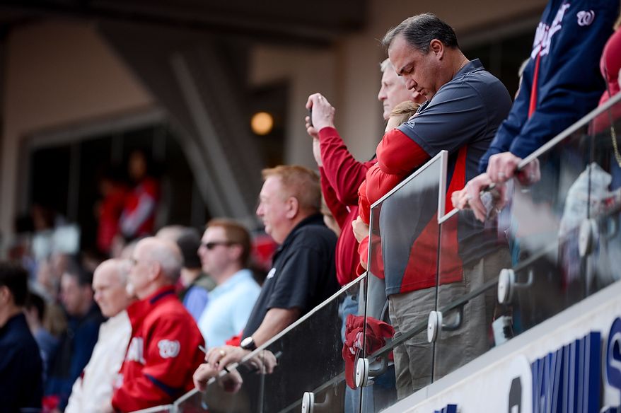 A moment of silence is taken for the victims of the school shooting in Newtown, Conn. before the Washington Nationals play the Miami Marlins on opening day at Nationals Park, Washington, D.C., Monday, April 1, 2013. (Andrew Harnik/The Washington Times)
