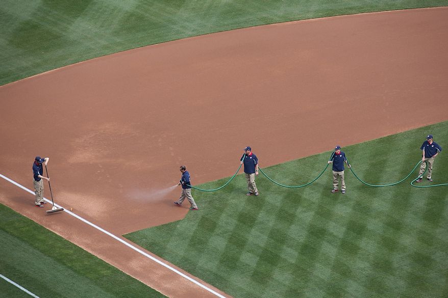 Grounds crews wet the field before the game starts, as the Washington Nationals play the the Miami Marlins on opening day, at Nationals Park, in Washington, DC., Monday, April 1, 2013. (Andrew S Geraci/The Washington Times)