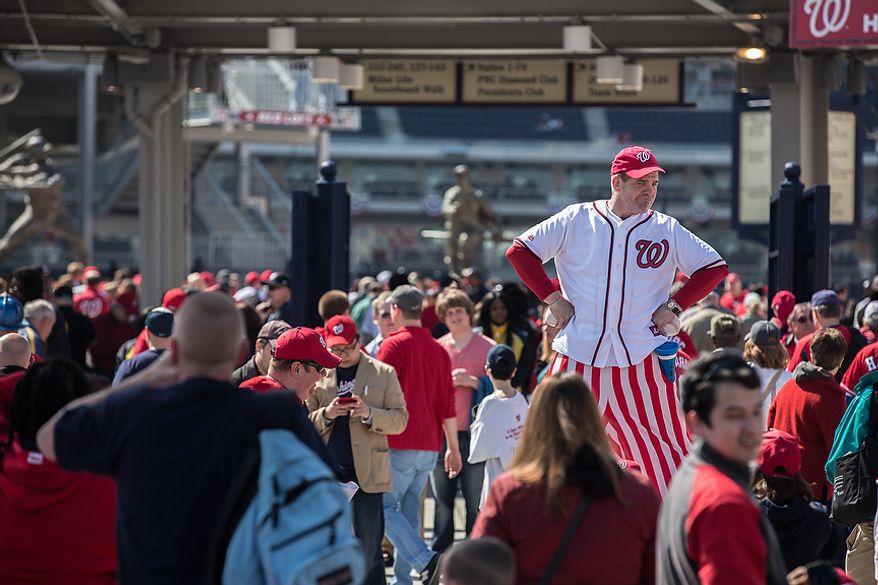 Mark Lohr, a stilt walker, greets fans as they enter the park to watch the Washington Nationals play the the Miami Marlins on opening day, at Nationals Park, in Washington, DC., Monday, April 1, 2013. (Andrew S Geraci/The Washington Times)