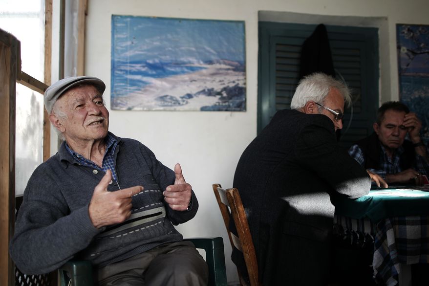 In this photo taken Sunday, March 24, 2013, Selcuk Ekendal, 72, speaks to The Associated Press inside a coffee shop in the Turkish Cypriot part of the divided capital Nicosia. (AP Photo/Petros Giannakouris)